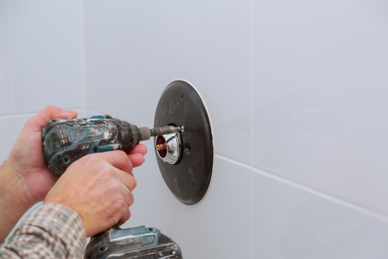 Installing a new on shower mixer tap in a bathroom — the kind of bath & shower work our vetted local pros handle in Sarasota, FL