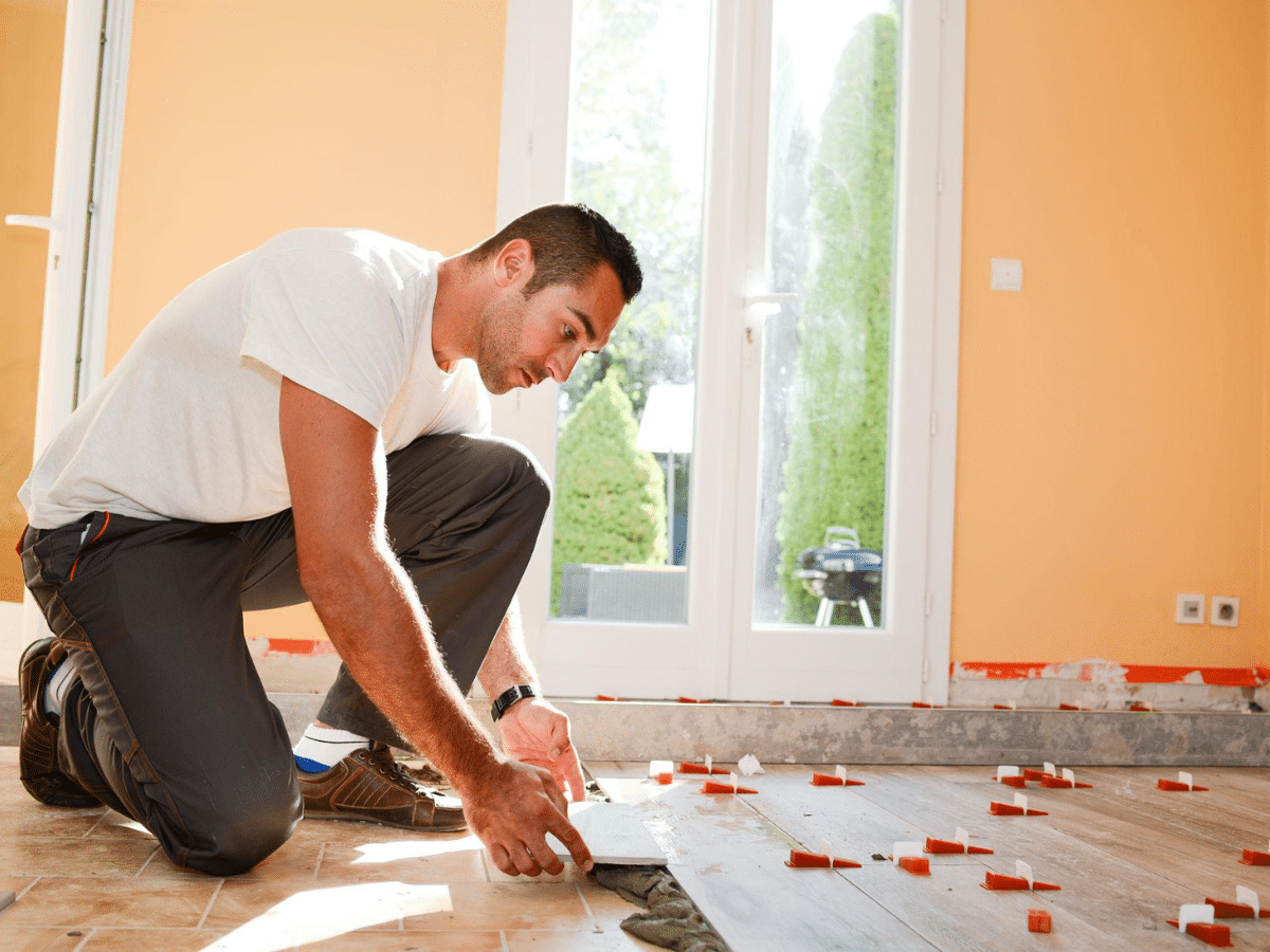 Handyman installing flooring and improving interior home structure for moisture resistance in Sarasota