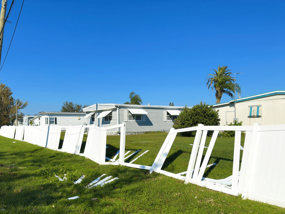 Handyman repairing and reinforcing fence