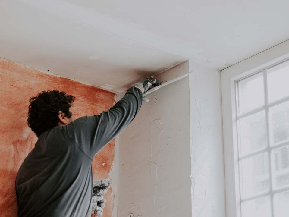 Smoothing fresh putty — drywall repair by vetted local pros