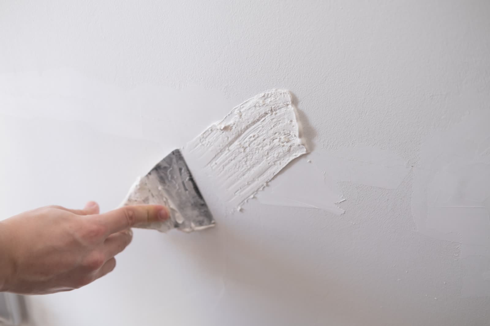 repairing walls with putty and spatula — Drywall Repair & Patching in Sarasota, FL