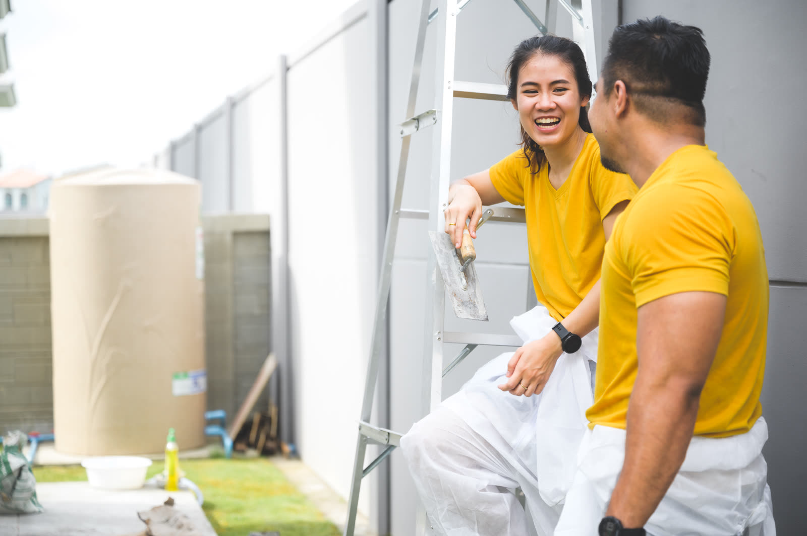 couple painting the wall lovely concept — Drywall Repair & Patching in Sarasota, FL