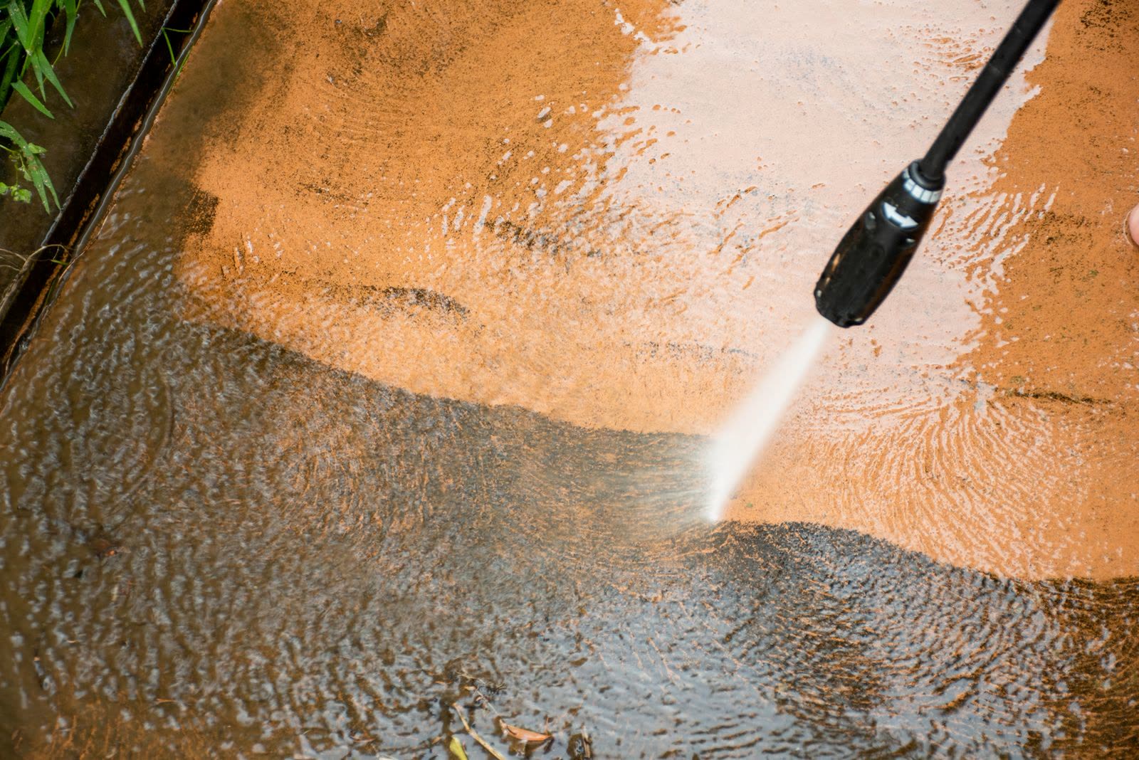 Backyard hardscape mid-wash — the kind of pressure washing our vetted local pros handle in Sarasota, FL