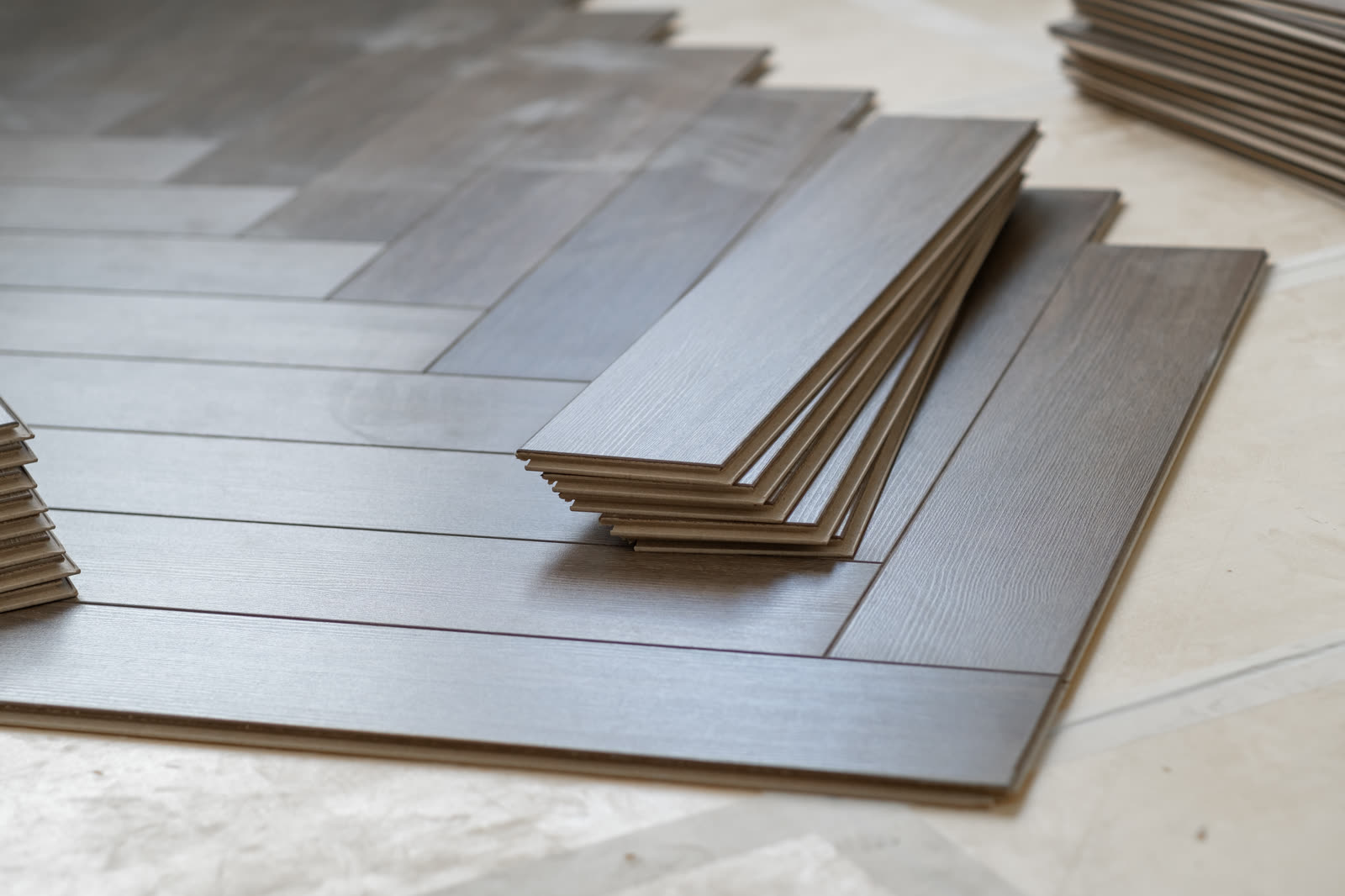 worker installing laminate flooring in a residenti — Tile and Flooring in Sarasota, FL