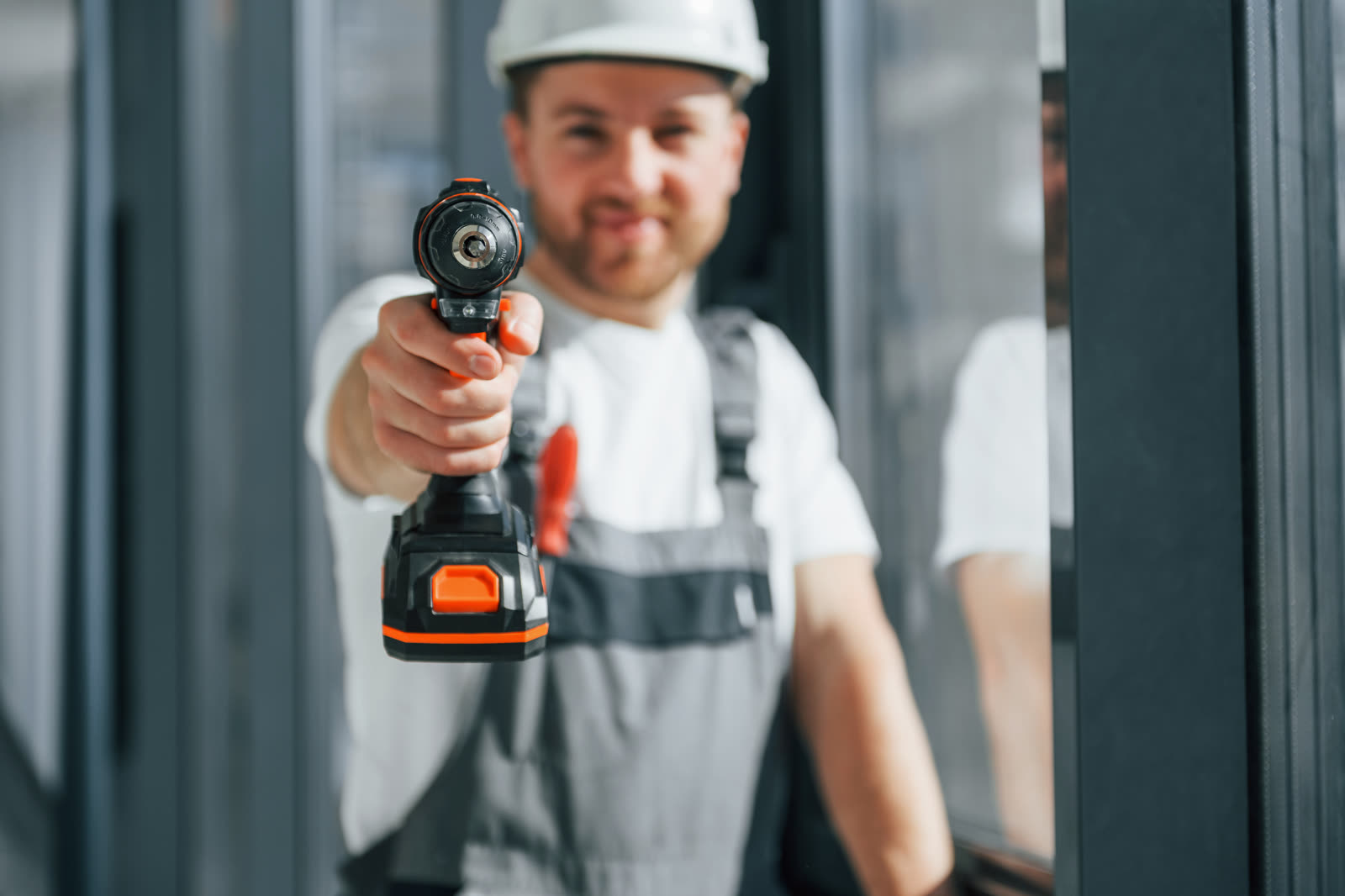working with windows repairman is indoors in the — Window AC Installation & Repair in Sarasota, FL